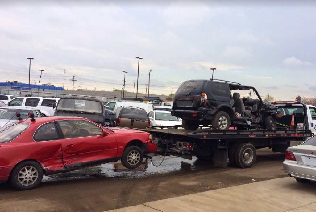 Flatbed Tow Truck Hauling A Vintage Car And Wreck Flatbed Tow Truck Hauling A Vintage Car And Wreck