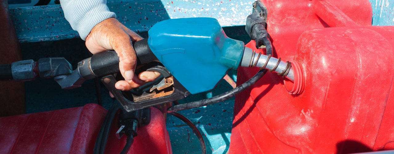 Man fueling tank of a motor boat before travel