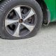 green car with a flat tire