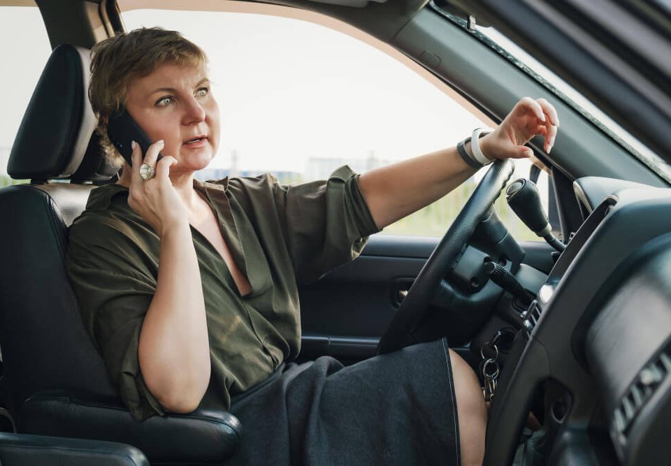 woman waiting for roadside assistance inside her car